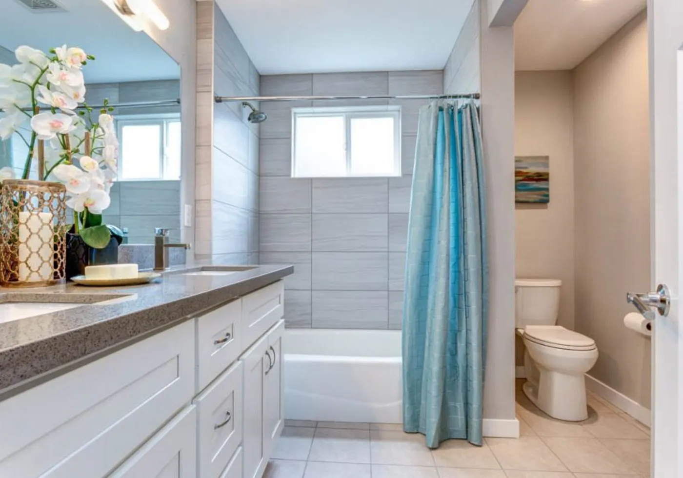 Remodeled bathroom with a tiled walk-in shower, freestanding tub, and new vanity
